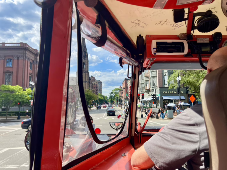 view of back bay boston neighborhood as seen through the windows and winshield of a boston duck tour boat